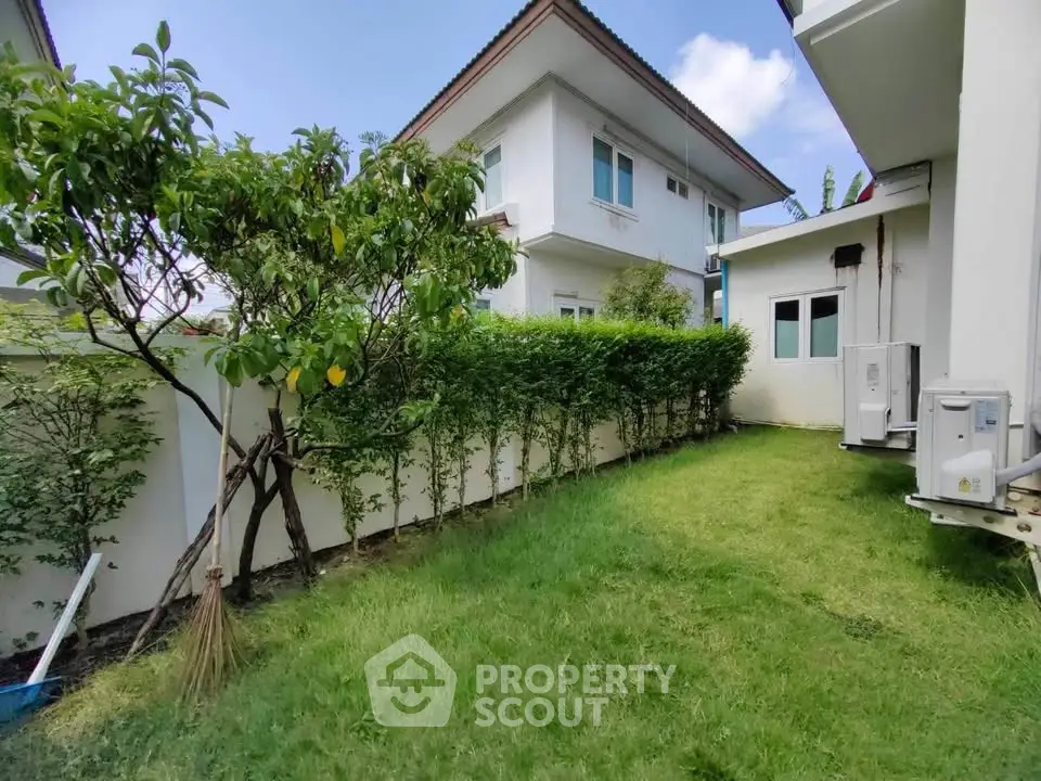 Charming suburban home with lush green garden and modern exterior design.