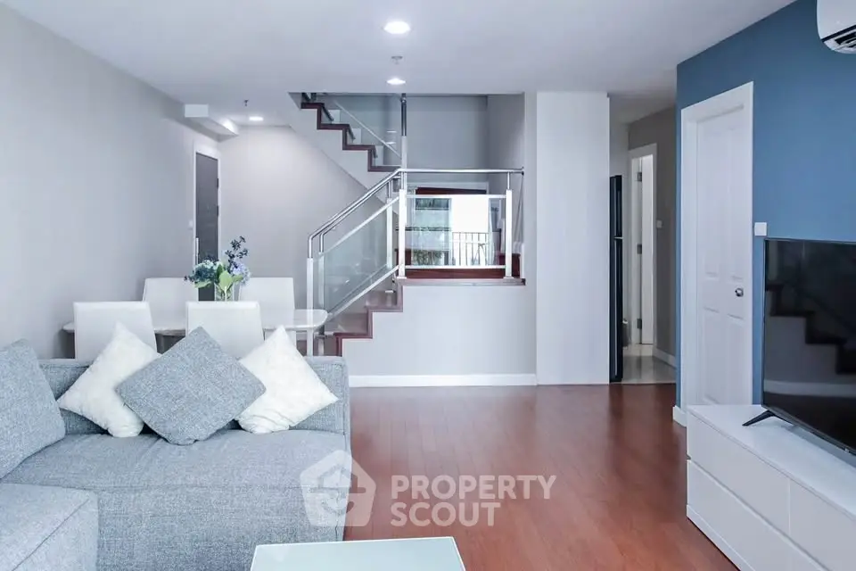 Modern living room with stylish furniture and staircase in a contemporary home