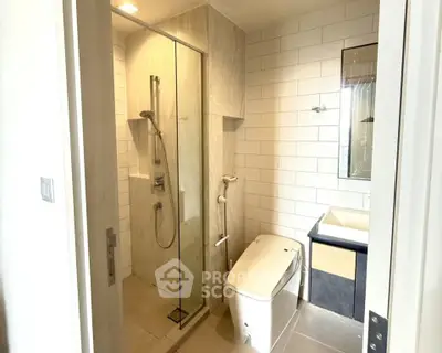 Modern bathroom with sleek shower and contemporary fixtures in a stylish apartment.