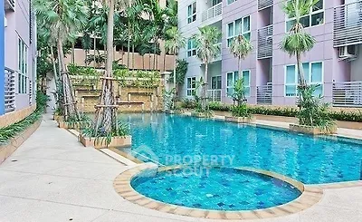 Luxurious residential pool area with palm trees and modern architecture