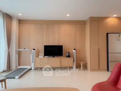 Modern living room with treadmill and sleek wooden furniture