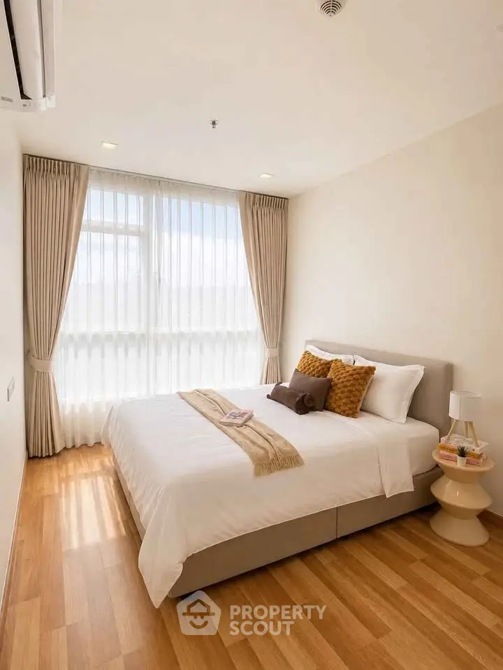 Bright and cozy bedroom with large window and elegant decor