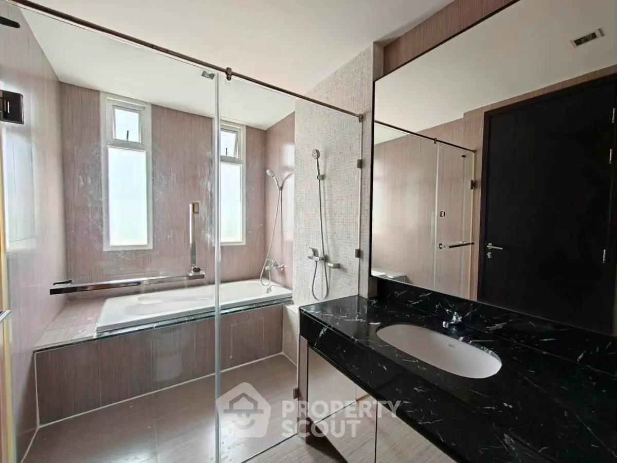 Luxurious modern bathroom with sleek design and elegant fixtures, featuring a spacious bathtub and stylish vanity.