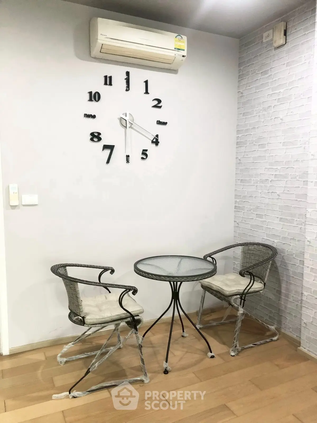 Cozy corner with modern clock and seating in stylish apartment