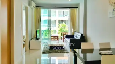 Modern living room with sleek furniture and balcony view in a stylish apartment.