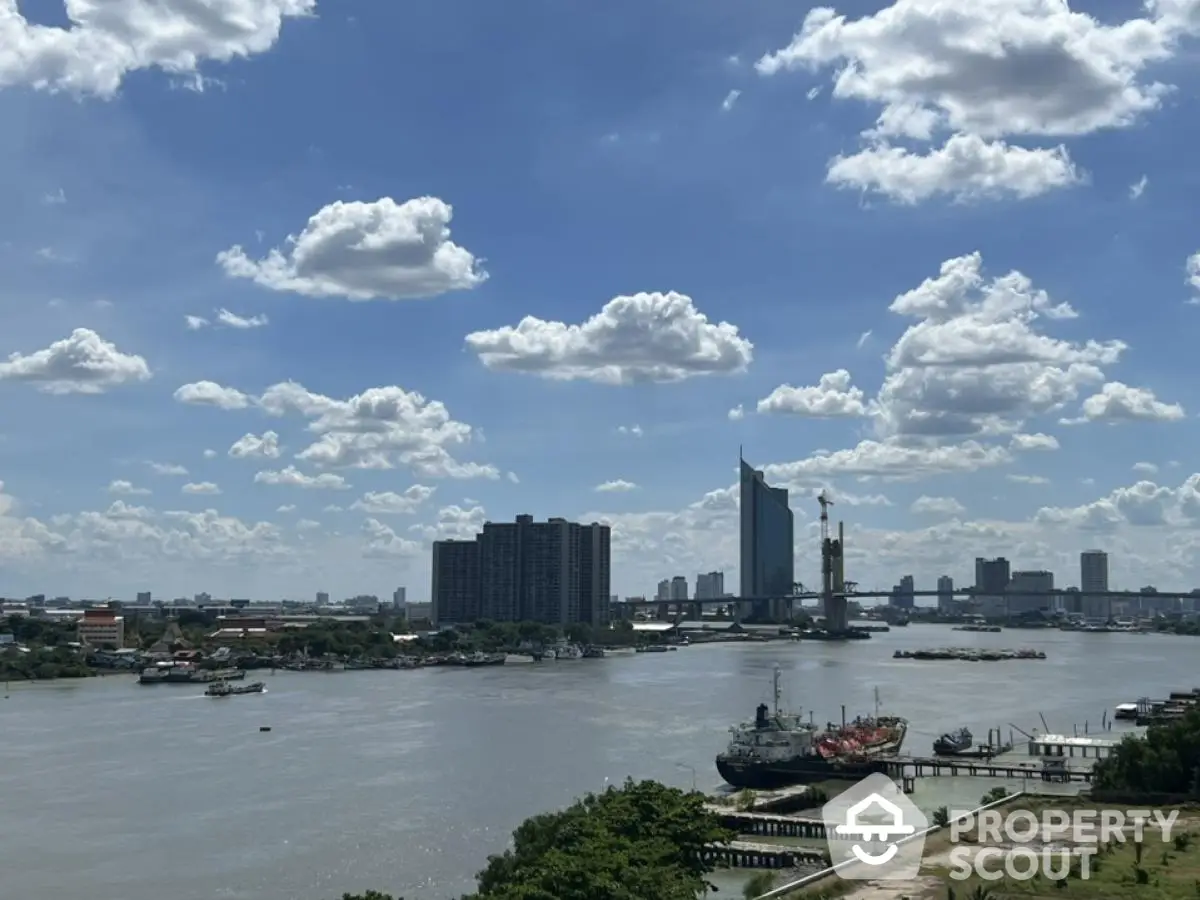 Stunning river view with city skyline and blue sky, perfect for urban living.