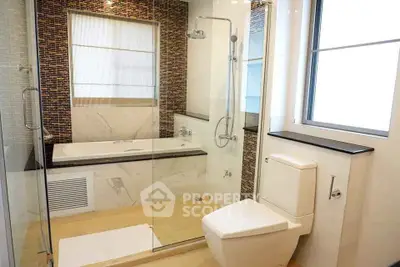 Luxurious modern bathroom with glass shower and elegant bathtub