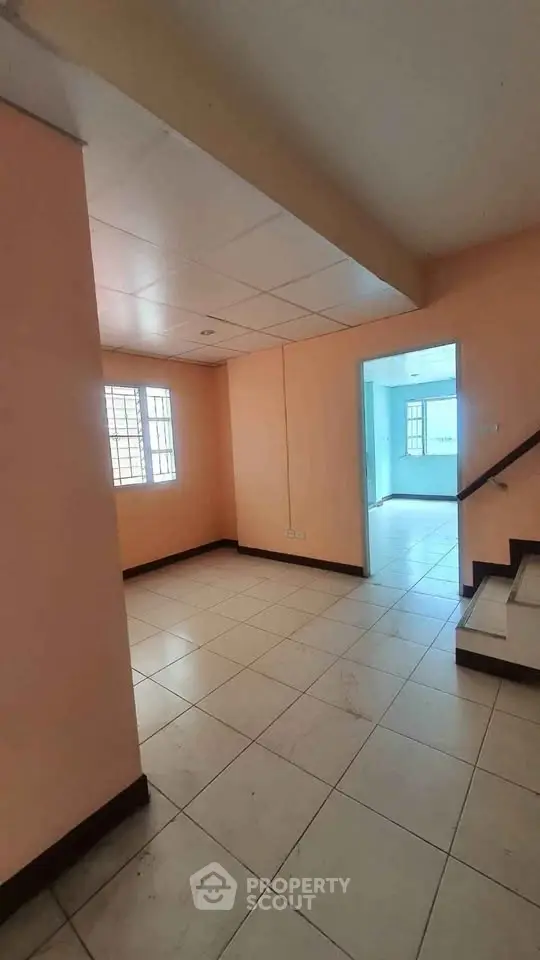 Spacious interior with tiled flooring and staircase, ideal for modern living.