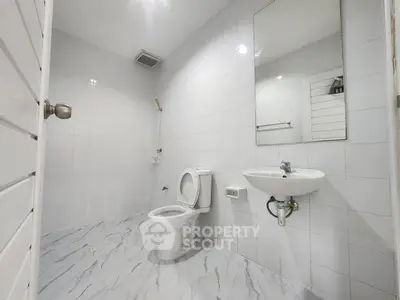 Spacious modern bathroom with sleek white tiles and elegant fixtures