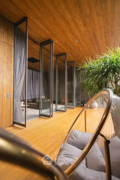 Luxurious modern living room with floor-to-ceiling windows and elegant wooden ceiling.