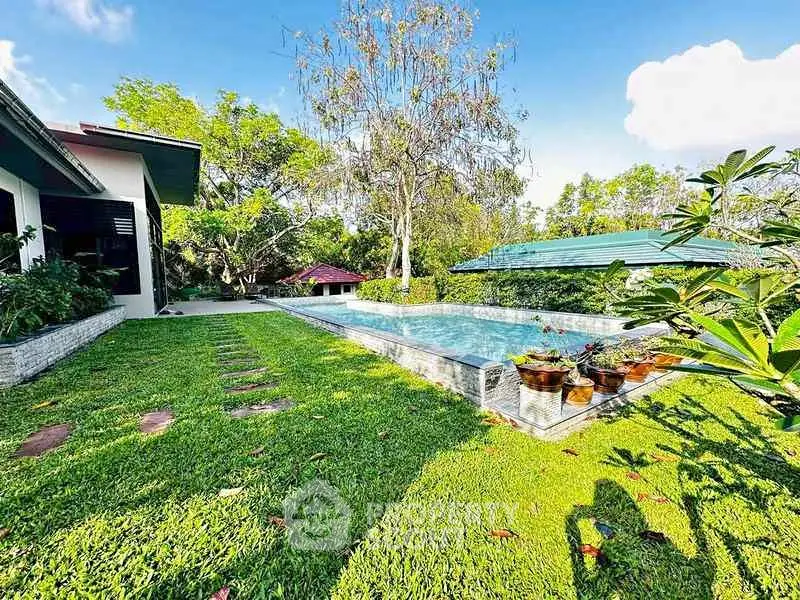 Luxurious property with stunning pool and lush garden, perfect for relaxation and outdoor enjoyment.