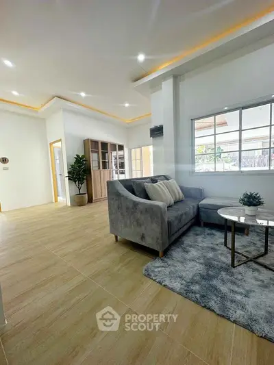 Spacious modern living room with elegant decor and large windows