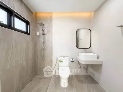 Modern minimalist bathroom with sleek fixtures and neutral tones.