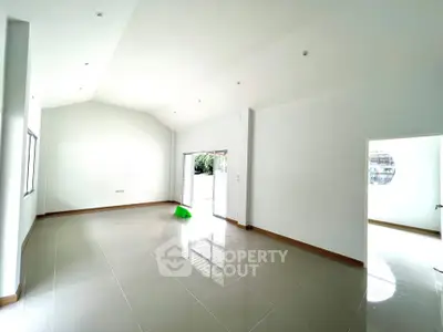 Spacious and bright living room with high ceilings and large windows in modern home.