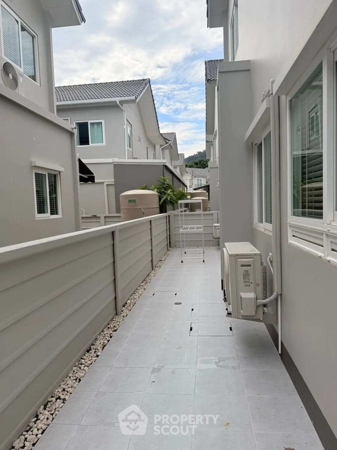 Modern townhouse exterior with sleek design and air conditioning unit