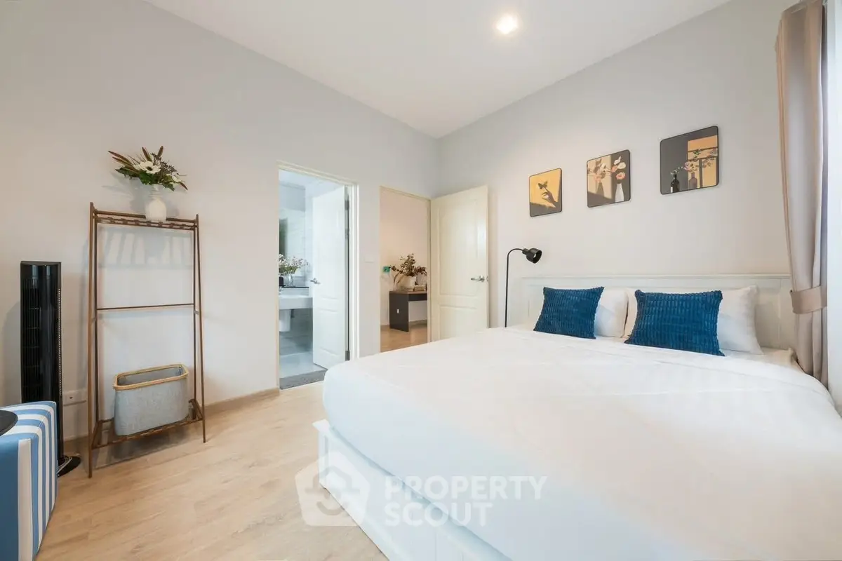 Spacious bedroom with modern decor and natural light