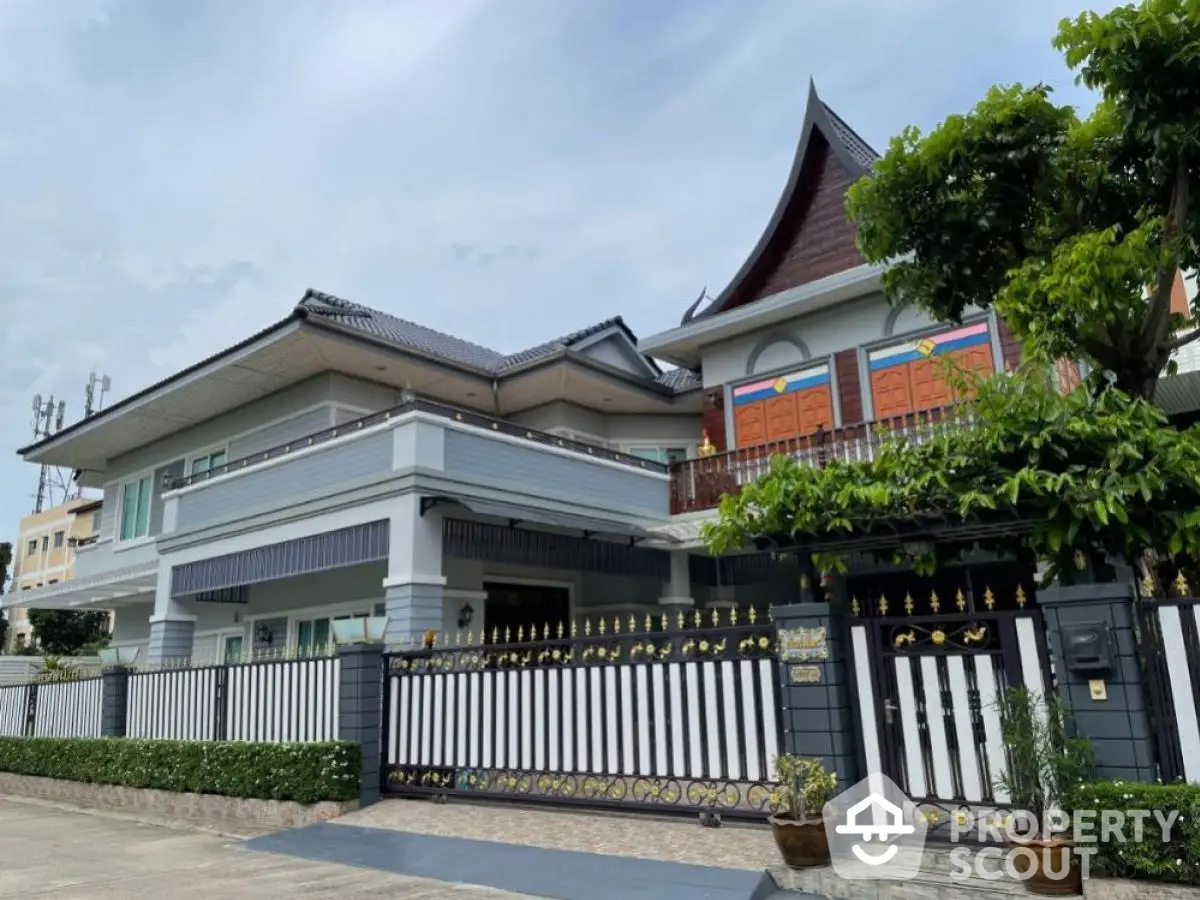 Stunning two-story house with unique architectural design and spacious balcony in a serene neighborhood.