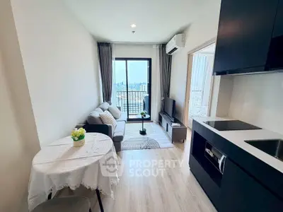 Modern living room with open kitchen and city view balcony in a stylish apartment.