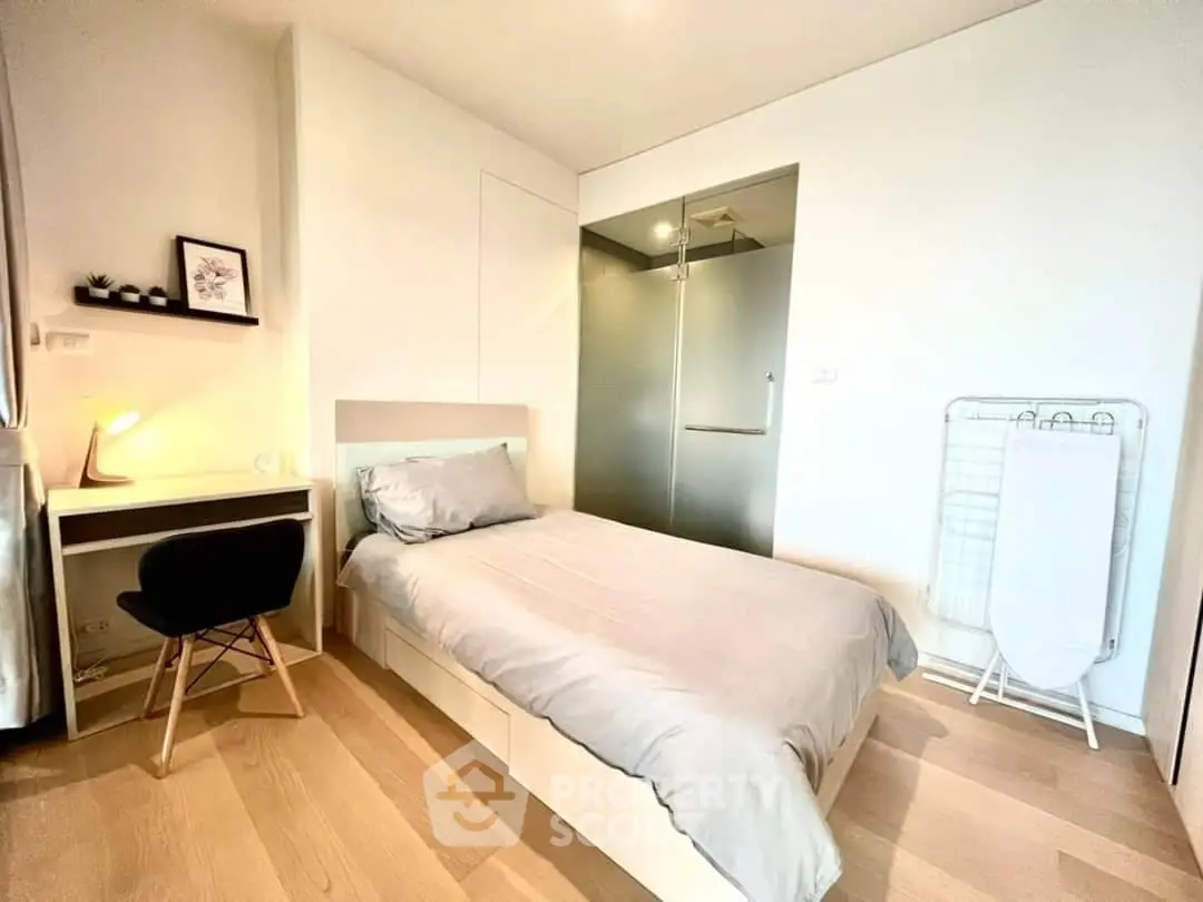 Modern minimalist bedroom with single bed and study desk, ideal for urban living.