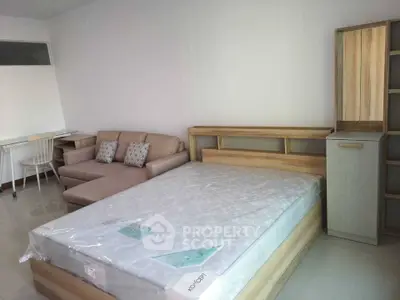 Modern bedroom with stylish furniture and cozy sofa, perfect for urban living.