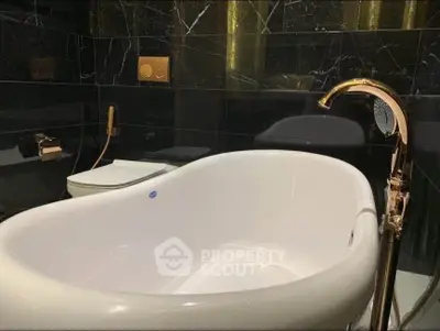 Luxurious bathroom with elegant bathtub and gold fixtures, perfect for relaxation and style.