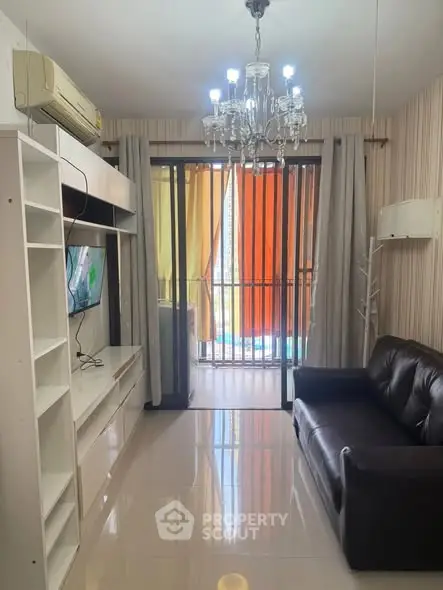 Modern living room with chandelier and balcony view