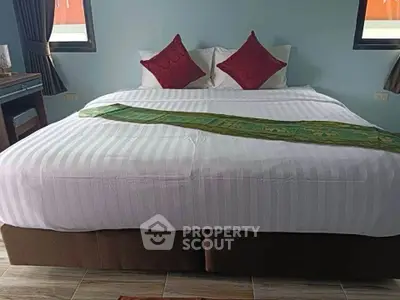 Spacious bedroom with elegant decor and comfortable bedding