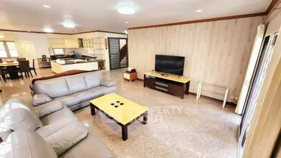 Spacious living room with modern furniture and open kitchen layout