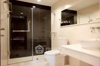 Modern bathroom with glass shower and sleek fixtures