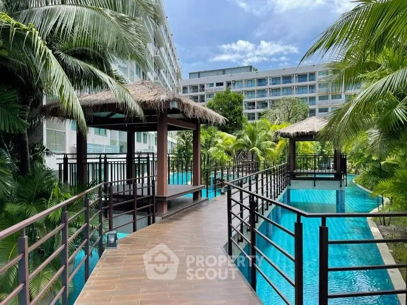 Luxurious resort-style pool area with tropical landscaping and modern architecture.