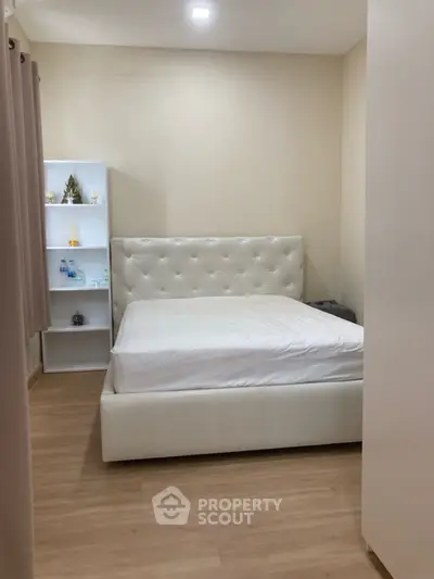 Cozy bedroom with elegant white tufted bed and minimalist decor