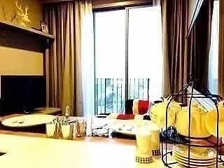 Cozy living room with modern decor and balcony view, perfect for relaxation.
