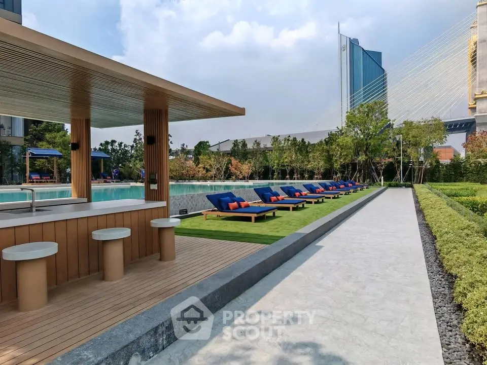 Luxurious outdoor pool area with modern sun loungers and lush greenery, perfect for relaxation and leisure.