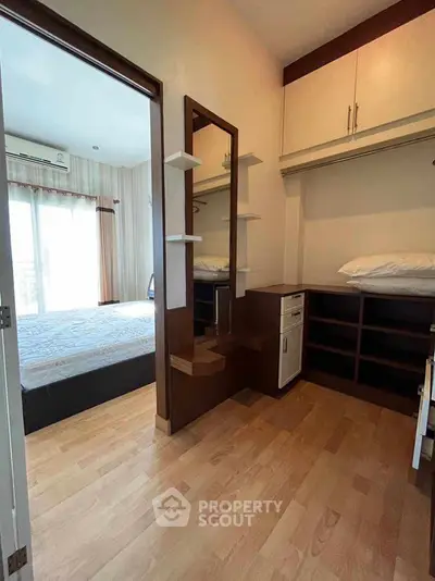 Spacious bedroom with built-in storage and natural light, perfect for modern living.