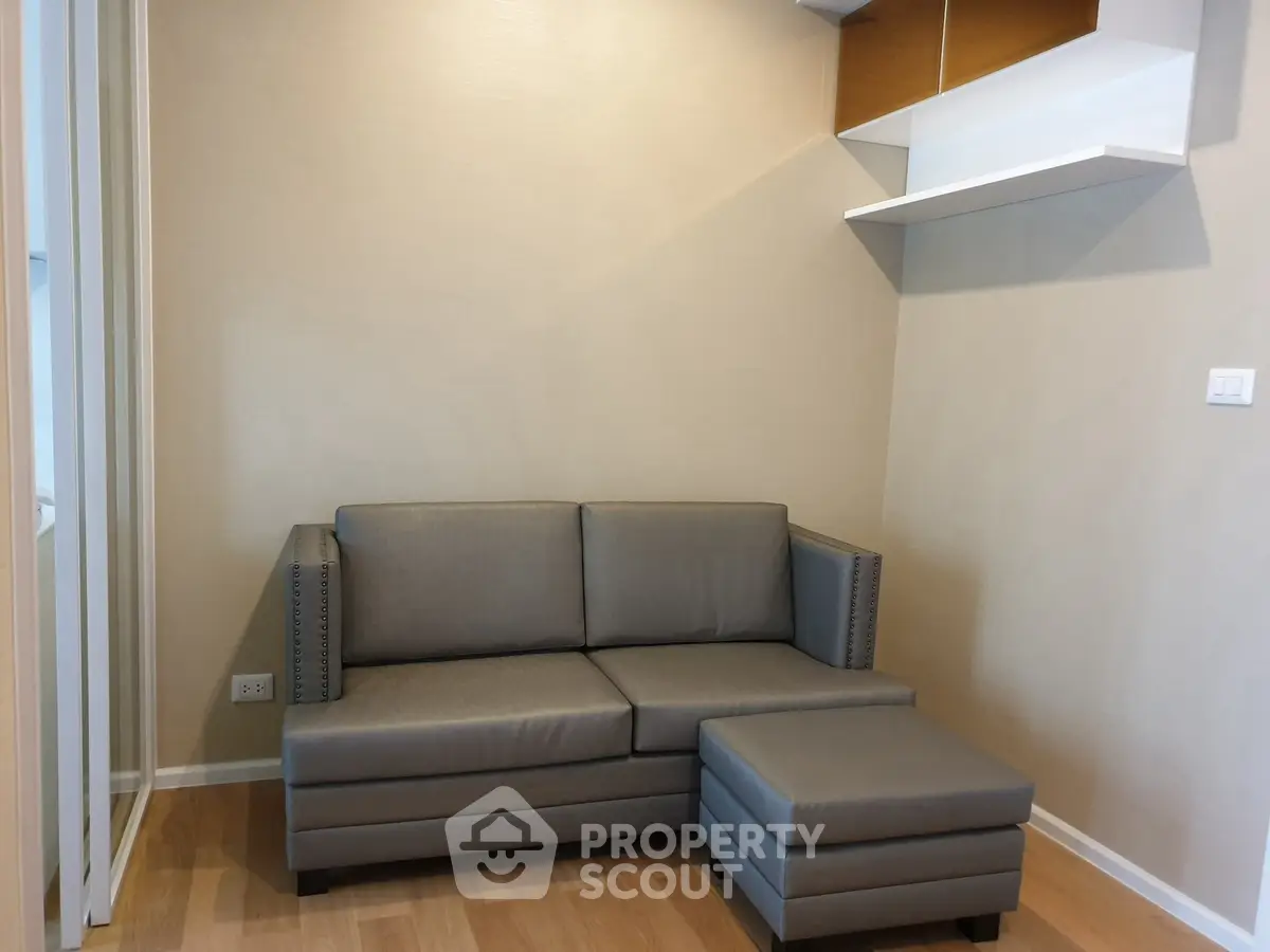 Modern living room with sleek gray sofa and wooden flooring