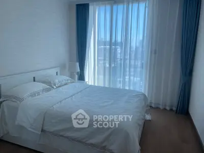 Bright and cozy bedroom with large window and elegant curtains