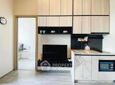 Modern kitchen with sleek cabinetry and marble countertops in a stylish apartment.