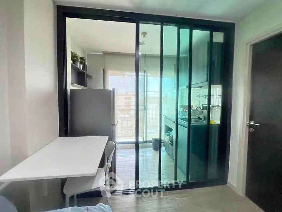 Modern kitchen with glass partition and dining area in a stylish apartment