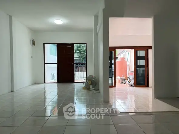 Spacious tiled living area with natural light and open layout