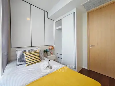 Modern bedroom with sleek design and ample storage in a stylish apartment.