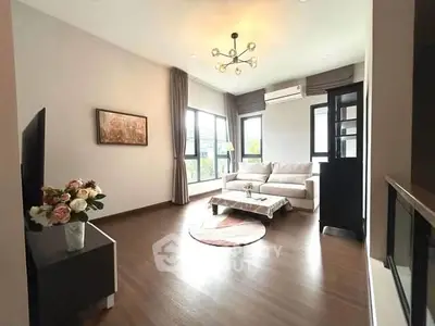 Spacious modern living room with elegant decor and large windows for natural light.