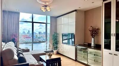Luxurious living room with stunning city and river view, featuring modern decor and ample natural light.