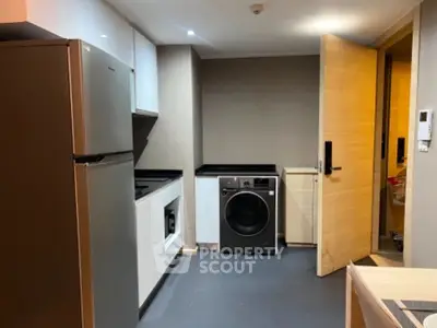 Modern kitchen with sleek appliances and ample storage space in a contemporary apartment.