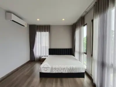 Spacious modern bedroom with large windows and elegant decor