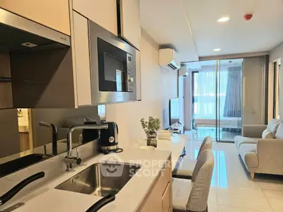 Modern open-plan kitchen and living room with sleek design and natural light