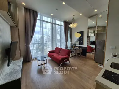 Modern living room with floor-to-ceiling windows and city view, featuring stylish red sofa and elegant decor.