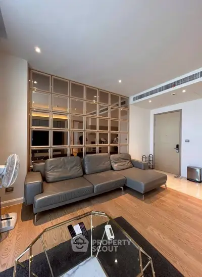 Modern living room with stylish sectional sofa and elegant wooden partition, perfect for contemporary urban living.