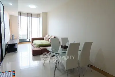 Modern living room with sleek furniture and large windows in a stylish apartment.