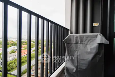 Stylish balcony with city view and covered outdoor furniture in modern apartment.