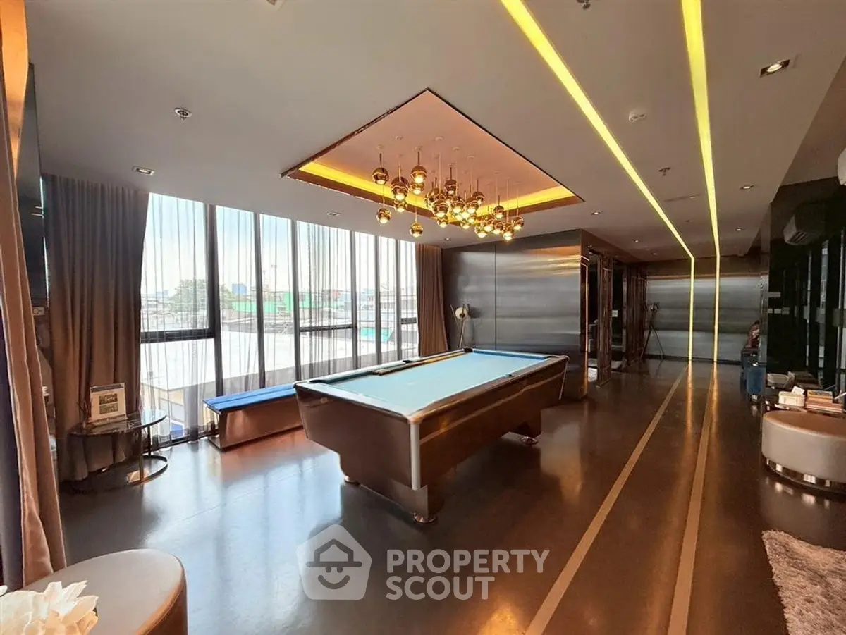 Luxurious modern living room with pool table and elegant lighting, perfect for entertainment and relaxation.